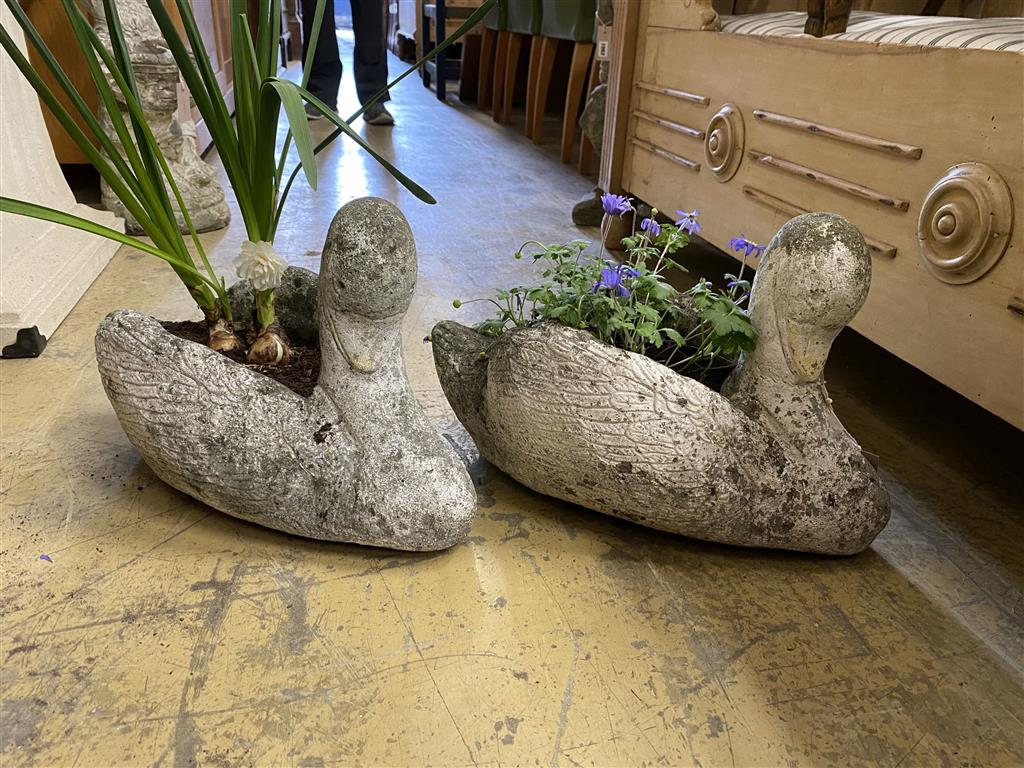 A pair of reconstituted stone swan garden planters, width 48cm, height 30cm